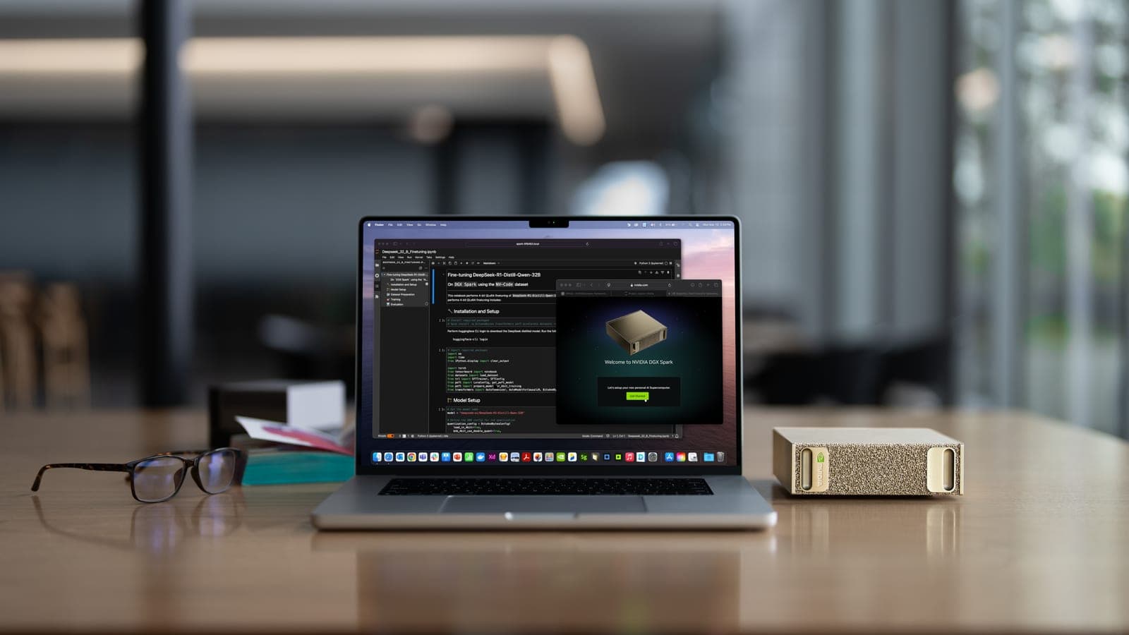 A laptop running a model fine-tuning notebook beside a DGX Spark